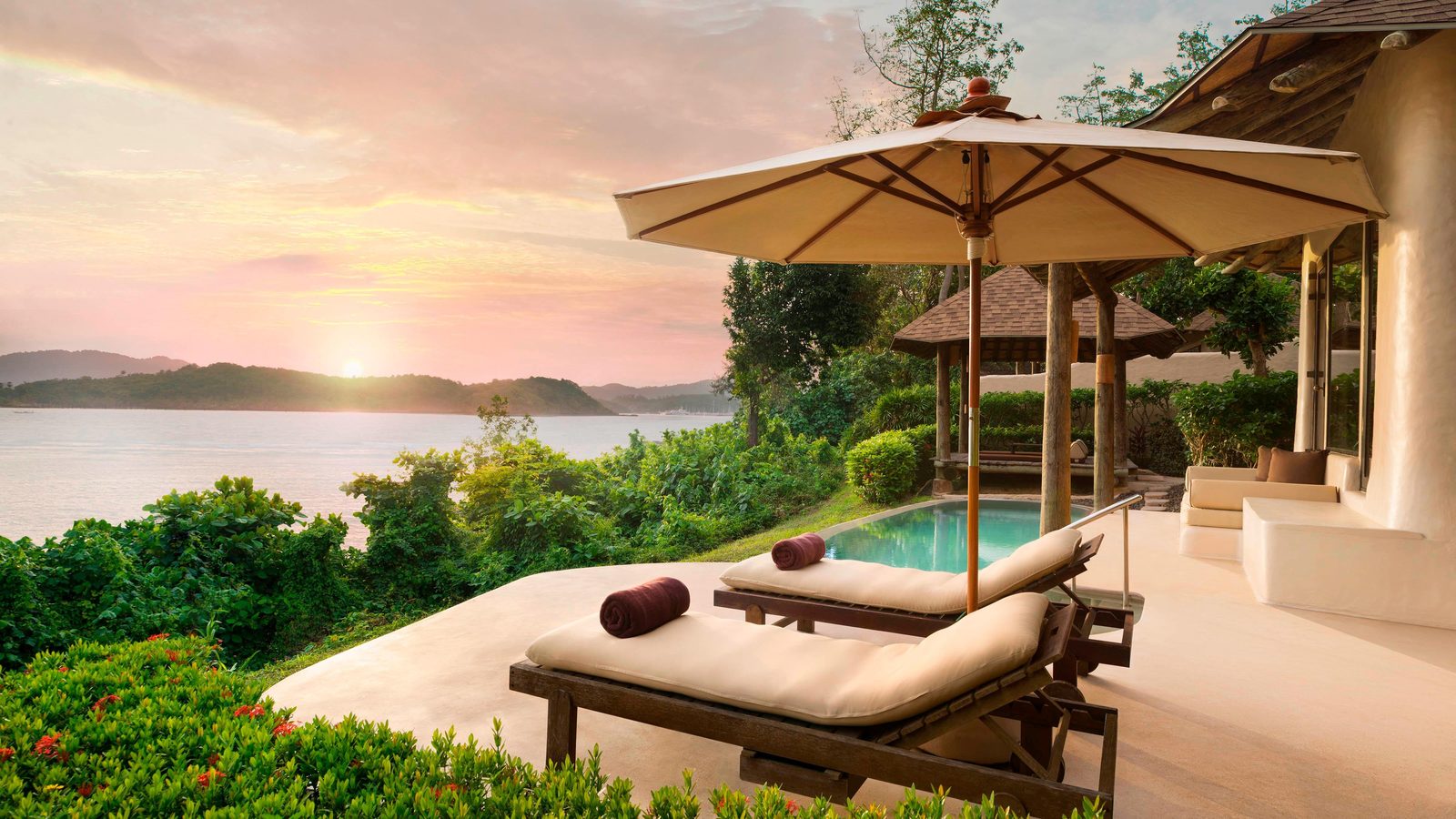 Seaview Pool Villa terrace with daybed and pool at sunset, The Naka Island
