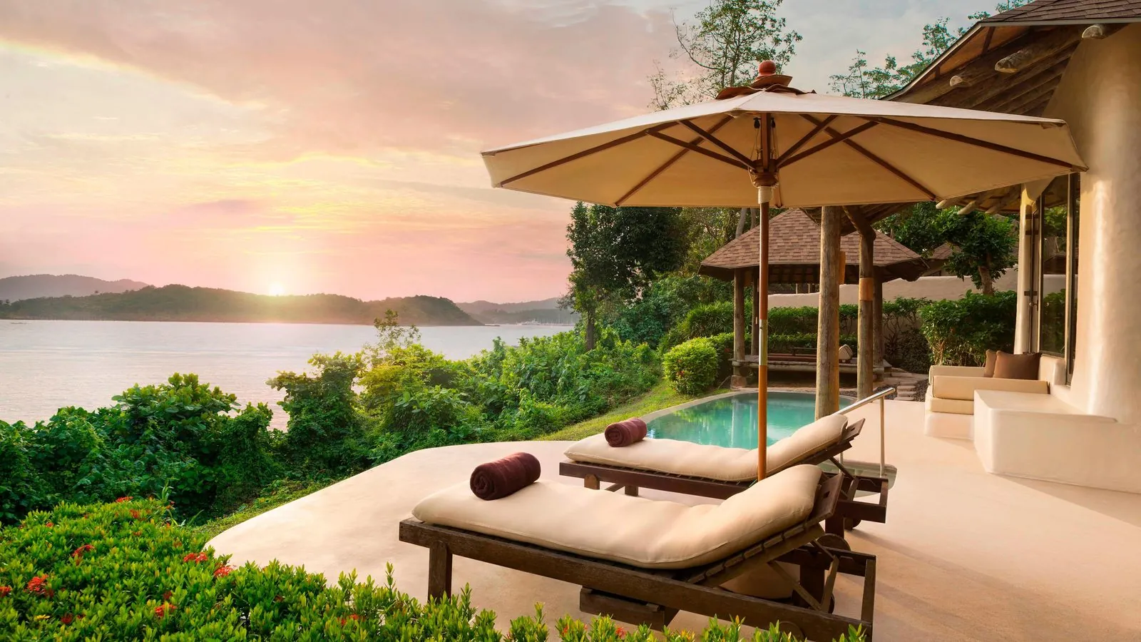 Seaview Pool Villa terrace with daybed and pool at sunset, The Naka Island