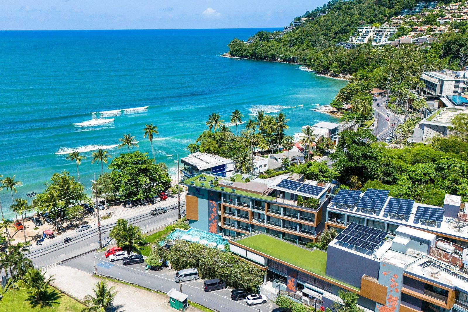 Aerial view of The Nature Phuket on the Kalim Bay coast road, with the sea and the Patong headland