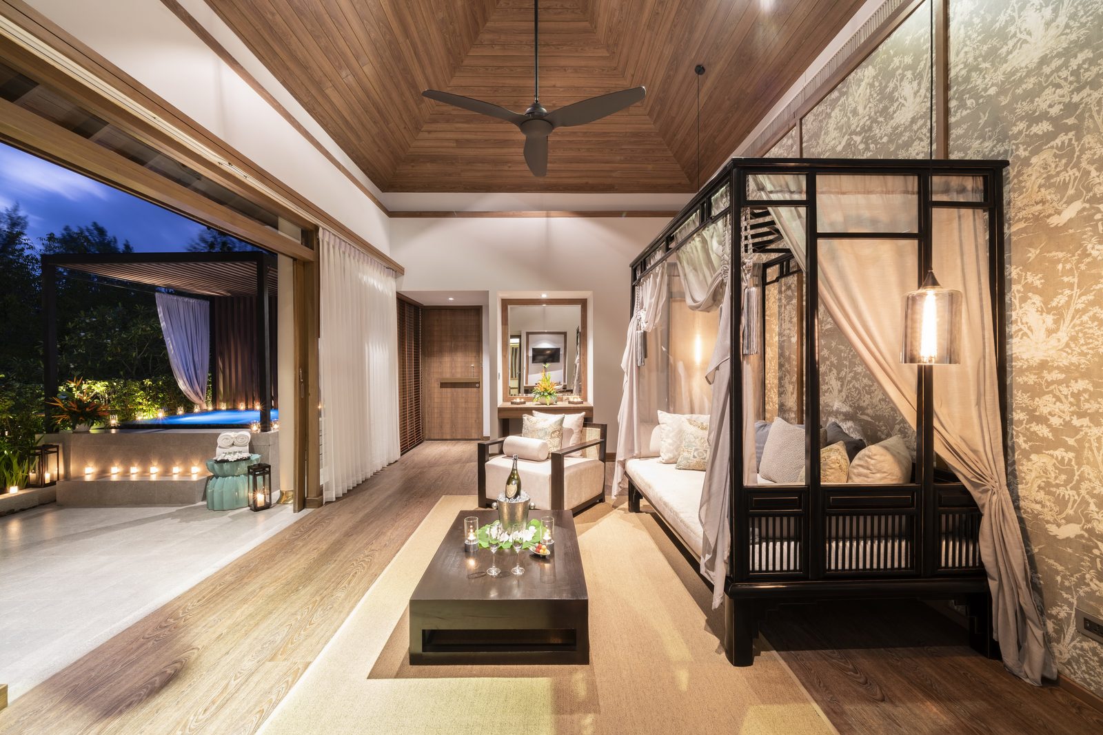 Jacuzzi Pool Suite bedroom and lounge with four-poster bed at The Sarojin