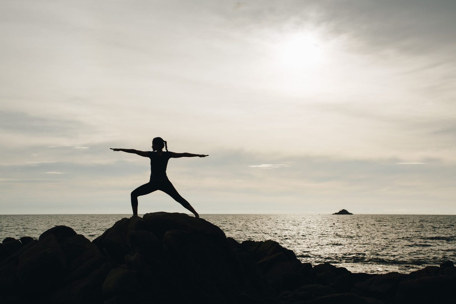 Yoga on the rocks at the waterfront at Trisara, Phuket