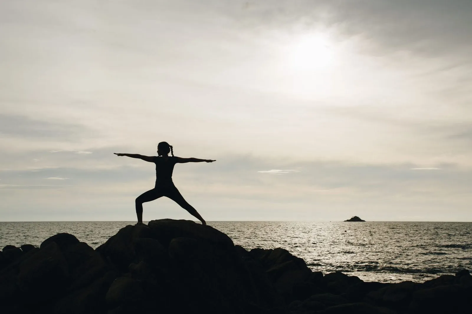 Yoga on the rocks at the waterfront at Trisara, Phuket