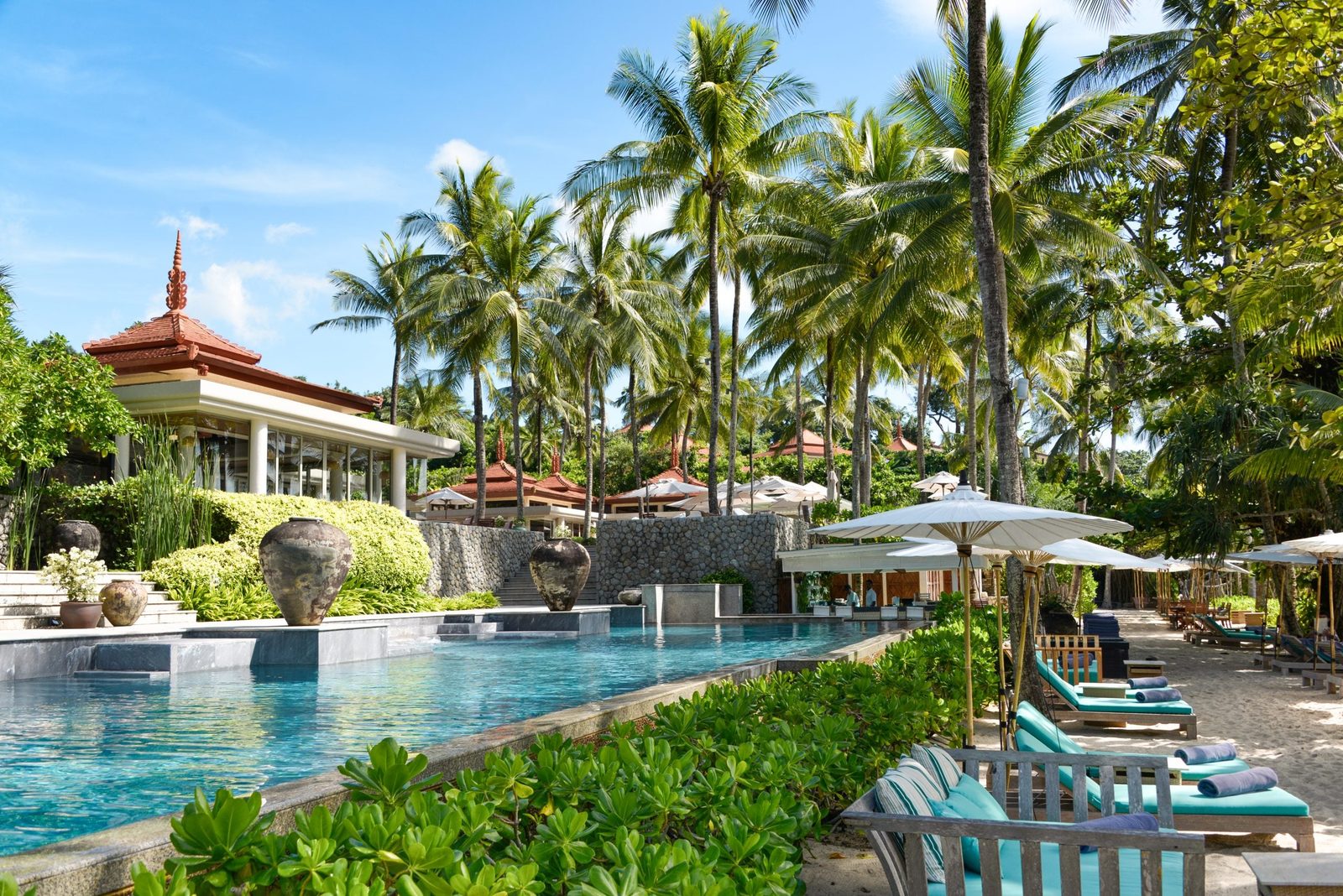 Main swimming pool with palms and loungers at Trisara, Phuket
