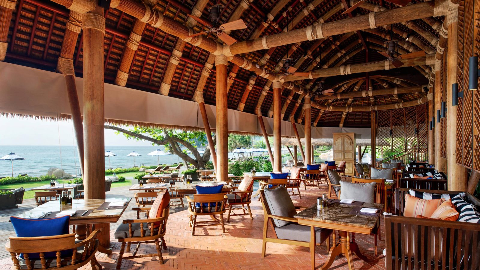 Panali Thai restaurant under its timber roof by the beach at Vana Belle