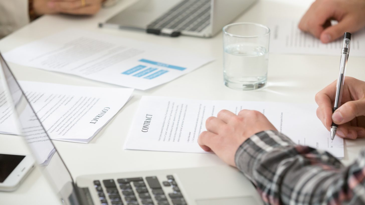 Reviewing licence and accreditation paperwork at a trade desk