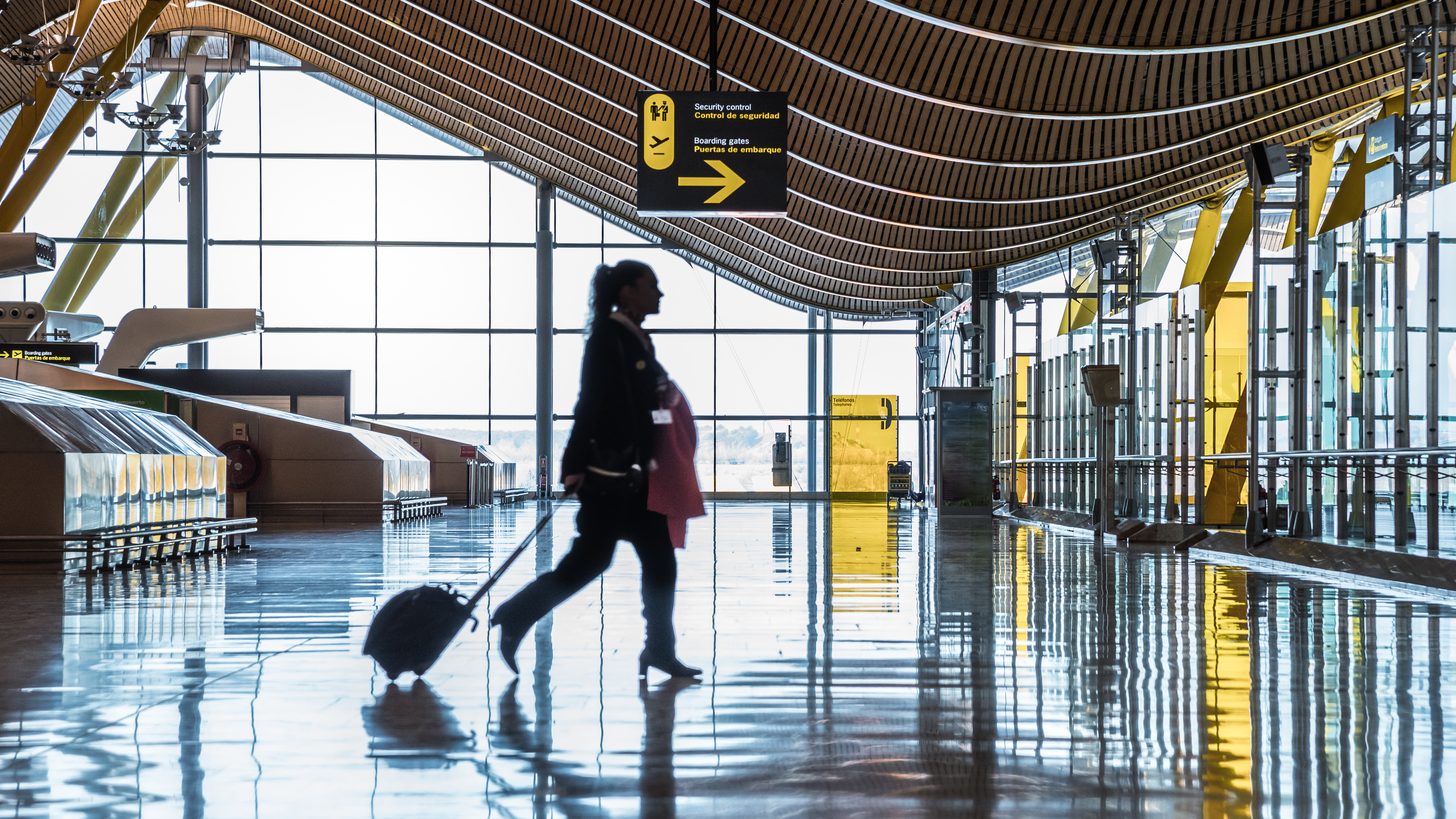 Travellers moving through an international airport terminal
