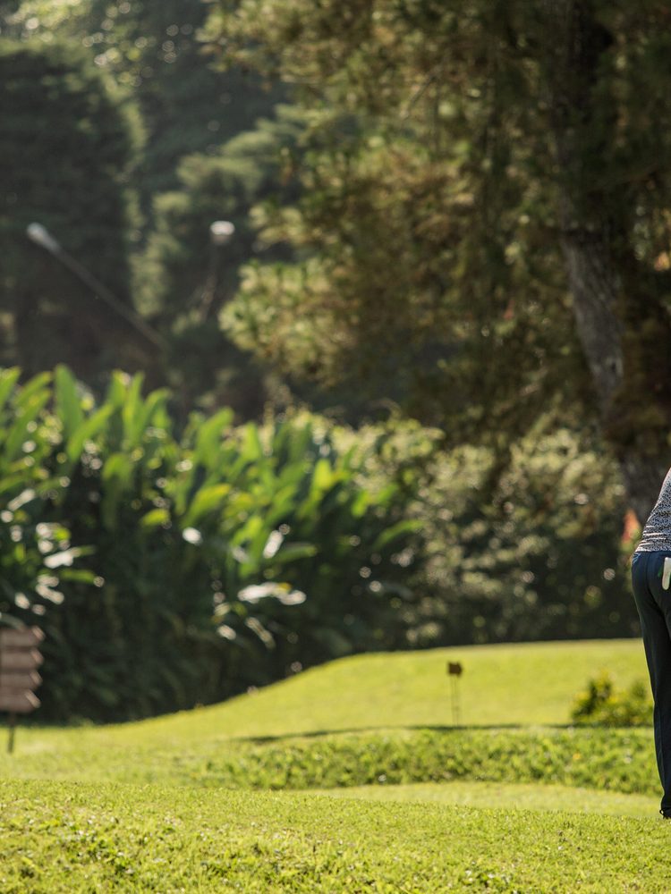 Golfer and caddie on a Thailand course