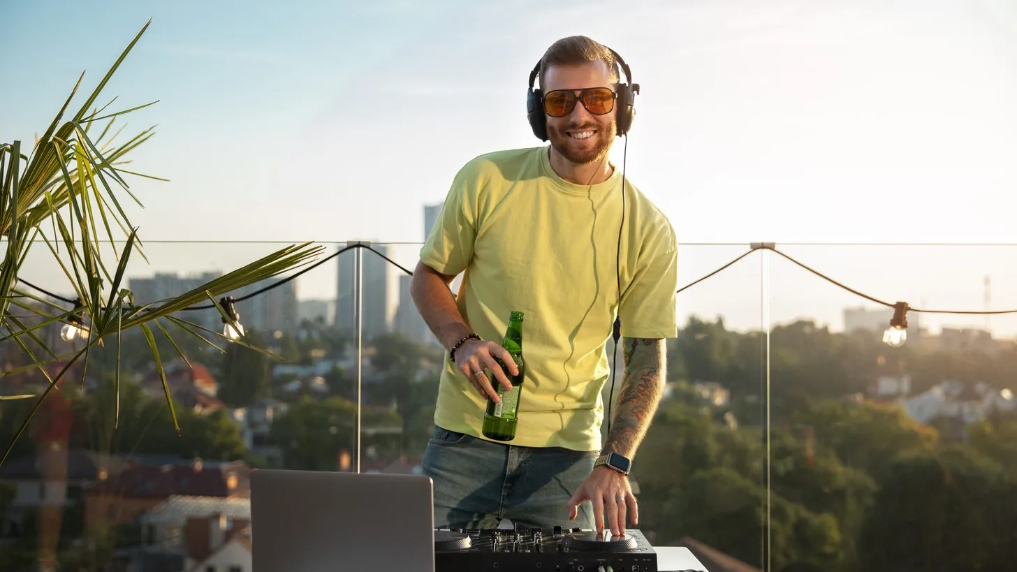 A DJ playing to a crowd at a night event