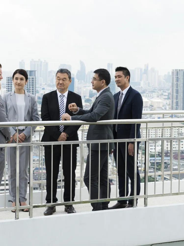 Business group on a city balcony overlooking high-rise buildings