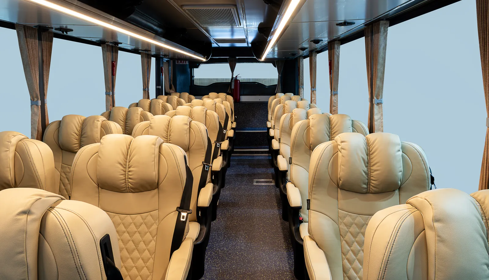 Rows of reclining leather seats inside a touring coach